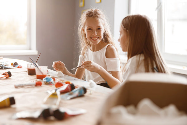 Two,Girlfriends,Talking,While,Painting,With,Watercolors,At,School