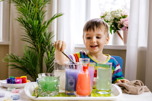 Cute,Baby,Boy,Learning,Mixing,Different,Colors,With,Water,And