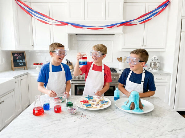 Kids making 4th of July kitchen science experiments and educational desserts.