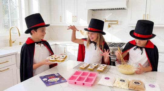 Children dressed as magicians baking Abracadabra Blondies in a kitchen, showing how magic tricks and baking combine to teach STEAM concepts.