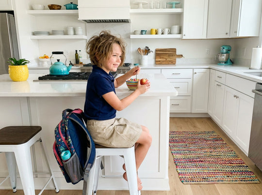 Child making easy after school snacks in the kitchen