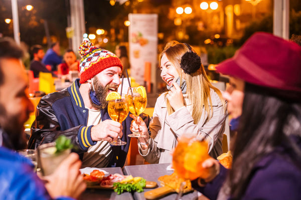 Man,And,Woman,Smiling,And,Toasting,Spritz,At,Winter,Cocktail
