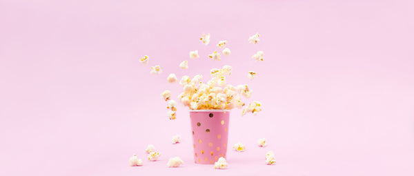 Flying,Popcorn,In,A,Bright,Glass,And,On,A,Pink