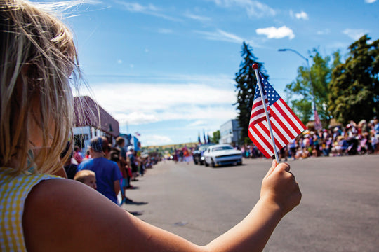 Girl,Holding,Usa,Flag,At,4th,Of,July,Parade,Festival