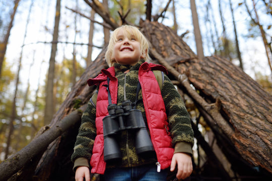 Little,Boy,Scout,With,Binoculars,During,Hiking,In,Autumn,Forest.