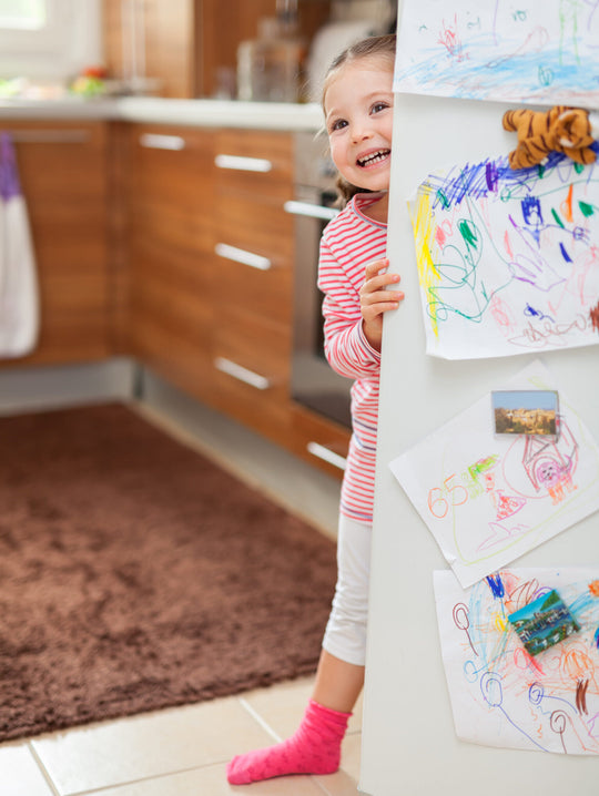 Little,Cute,Girl,Smiling,Behind,Refrigerator,Door,In,Kitchen.