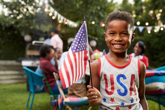 Young,Black,Boy,Holding,Flag,At,4th,July,Family,Garden