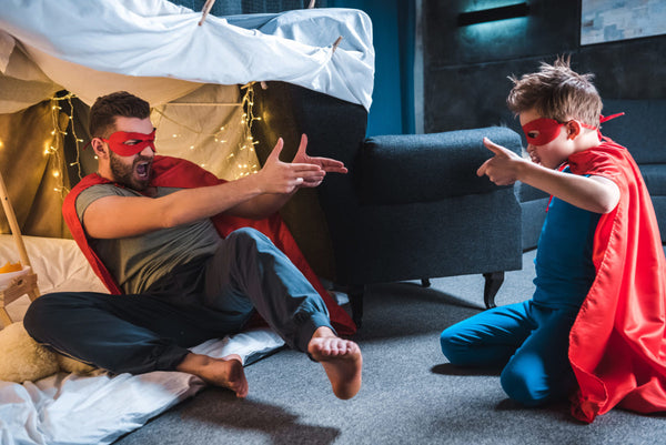Father,And,Son,In,Red,Superhero,Costumes,Playing,At,Home